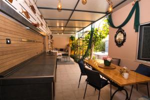 a restaurant with a long communal table and chairs at Central Beach Retreat in Trogir