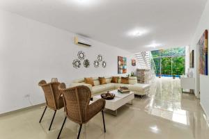 a living room with a couch and a table and chairs at Casa Lula 5-BR Getaway in Riviera Maya in Playa del Carmen