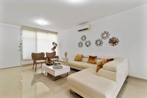 a living room with a couch and a table at Casa Lula 5-BR Getaway in Riviera Maya in Playa del Carmen