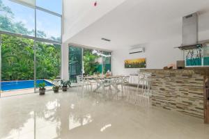 a kitchen and living room with a table and chairs at Casa Lula 5-BR Getaway in Riviera Maya in Playa del Carmen +101 photos