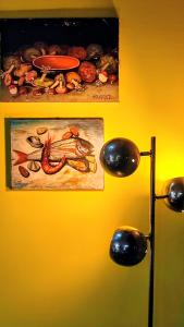 a yellow wall with a picture of a lobster on it at La Demeure du Figuier in Évran +52 photos