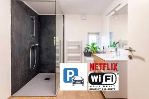 a bathroom with a sink and a shower with a sign at Appartement "L'orée des trois frontières" in Allondrelle-la-Malmaison +23 photos