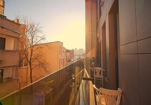 a balcony with chairs and a view of a city at Old Town Boutique Hotel in Bucharest +103 photos
