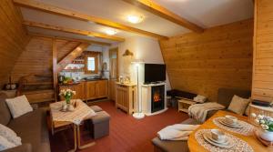 a living room with a couch and a fireplace at CHATKA ŠTÔLA in Vyšné Hágy