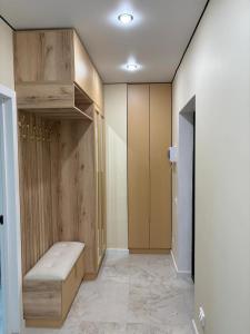a room with a closet with a bench in it at Turar apartments in Almaty