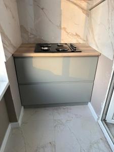 a kitchen with a stove top on a counter at Turar apartments in Almaty