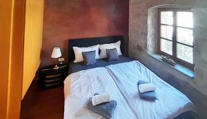 a bedroom with a white bed with pillows and a window at VISTA ART sea view in Funtana