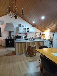 a kitchen with blue cabinets and a wooden ceiling at CASA do AÇÔR in Aldeia das Dez