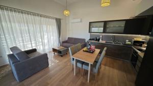 a kitchen and a living room with a table and chairs at Tago Houses in Elafonisos