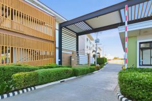 a sidewalk next to a building with bushes at LunaVista in Bankal