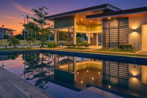 a house with a pool in front of it at LunaVista in Bankal