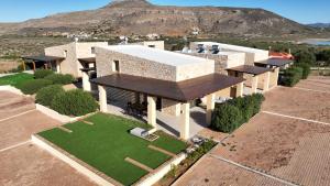 an overhead view of a house with a green lawn at Tago Houses in Elafonisos