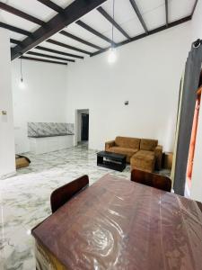 a dining room with a table and a couch at Anchorage Apartment in Kurunegala