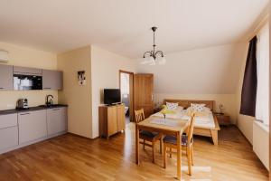 a kitchen and dining room with a table and chairs at Gästezimmer & Weingut Gamser in Leutschach