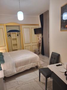 a hotel room with a bed and a desk and a chair at Soleil in Nicosia