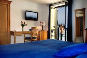 Letto o letti in una camera di B&B L'Approdo