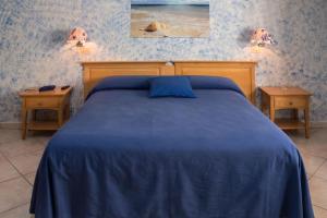 Letto o letti in una camera di B&B L'Approdo