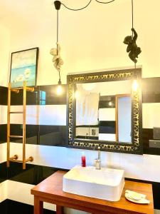 a bathroom with a sink and a mirror at Casa Monkey 28 in Bentota
