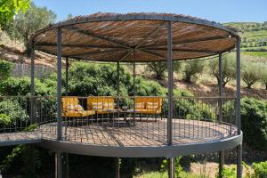 a metal circular patio with chairs and a table at Quinta do Vallado - Douro Wine Hotel in Peso da Régua +89 photos