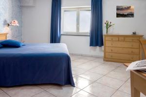 Letto o letti in una camera di B&B L'Approdo