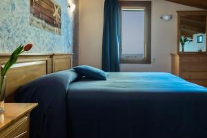 Letto o letti in una camera di B&B L'Approdo
