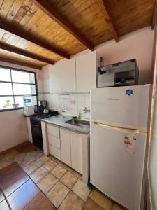 a kitchen with a refrigerator and a sink at Patagonia Faro Norte Lighthouse in Carmen de Patagones +9 photos