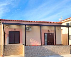 a house with a porch with a black door at Country House Ortensie in Torre del Greco