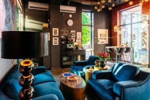 a living room with blue couches and a table at Cocorico Bed and Breakfast OLD TOWN Szczecin Adults Only in Szczecin