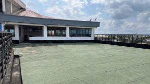 a building with a large patio with a view of the ocean at TOU R serjo polo in Douala