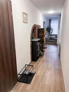 a hallway with a room with a brick fireplace at V Talutě in Chyšky