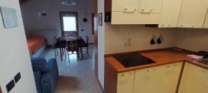 a kitchen and a dining room with a table at Casa Vacanze Da Ile 2 in Malborghetto Valbruna