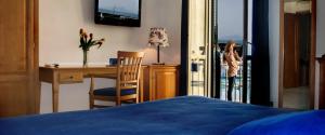 Letto o letti in una camera di B&B L'Approdo