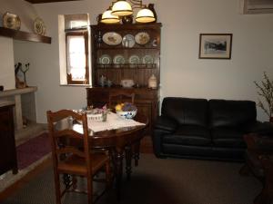 a living room with a table and a couch at Casa de RioBom in Soajo