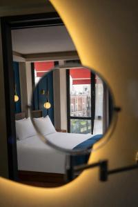 a view of two beds in a room with a mirror at Priede Hotel Boutique in Puebla +17 photos