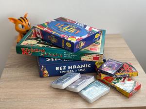 a stack of video games and other games on a table at V Talutě in Chyšky