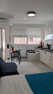 a kitchen with a bed and a table in a room at Christina's Studio in Kalabaka +14 photos