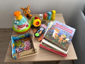 a table with two books and other toys on it at V Talutě in Chyšky +32 photos