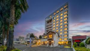 a tall building with lights on in a city at Holiday Inn Express Quito by IHG in Quito