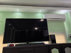 a large flat screen tv sitting on top of a dresser at Comfortable apartment in downtown Reynosa in Reynosa