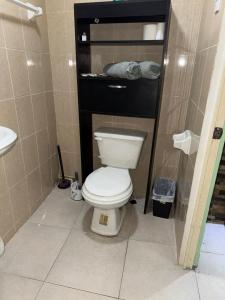 a bathroom with a white toilet and a sink at Comfortable apartment in downtown Reynosa in Reynosa +5 photos