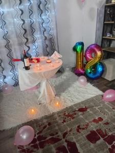 a birthday party with a table and balloons at Raffaello's Villa in Vlorë