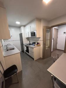a small kitchen with a sink and a microwave at Los Soportales in Soria