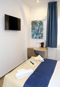 a room with a bed and a desk and a tv at Nastanza D'arte in Mazara del Vallo +21 photos