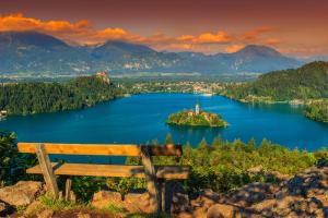 an island in the middle of a lake with a bench at Apartment Ivana B in Lesce