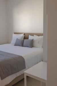 a large bed with white sheets and pillows at Casa da Pegada in Macedo de Cavaleiros +13 photos