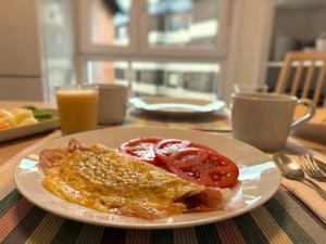 a plate of food with eggs and tomatoes on a table at Casa Carlini in Getxo