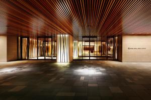 an empty lobby of a building with windows at RIHGA Royal Hotel Kyoto in Kyoto