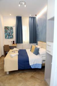 a bedroom with a large bed with blue and white at Nastanza D'arte in Mazara del Vallo