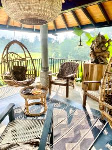 a porch with rattan chairs and a table at Casa Monkey 28 in Bentota