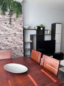 a dining room table with chairs and a fireplace at Los Soportales in Soria +14 photos
